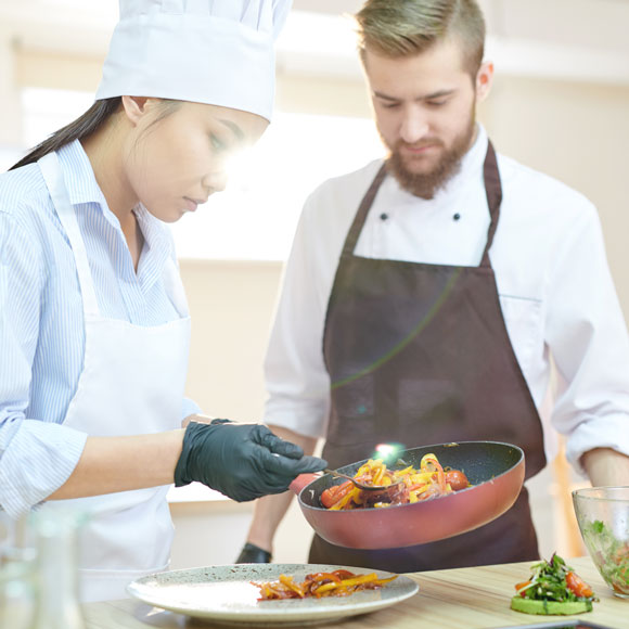 Catering Insurance: Caterers dishing some food 