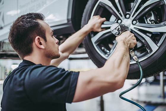 Employers Liability Insurance: Pic of mechanic fixing a tyre